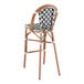 A black and white birdseye weave rattan outdoor barstool.