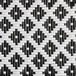 A close up of a black and white woven mat with a birdseye pattern.