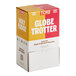 A white box of TCHO Globe Trotter assorted dark chocolate squares with orange accents and white text on a counter.