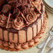 A plate of chocolate cake slices with brownie pieces on top.