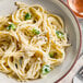 A plate of pasta with broccoli and Trio Alfredo Sauce.