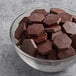 A bowl of TCHO Real Fudgy 70% Dark Chocolate Hexagons.