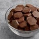 A bowl of TCHO 68% dark chocolate hexagons.