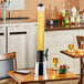 A table with a Choice silver beer tower and a glass of beer on it.