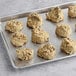 A baking tray filled with Otis Spunkmeyer Oatmeal Raisin cookies.