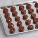 A tray of brown Otis Spunkmeyer double chocolate chip cookies.