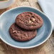 Preformed Otis Spunkmeyer double chocolate chip cookies on a plate.