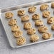 A baking tray filled with Otis Spunkmeyer Oatmeal Raisin cookie dough.