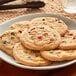 A plate of Otis Spunkmeyer Carnival cookies with colorful sprinkles.