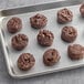 A preformed brown Otis Spunkmeyer double chocolate brownie cookie on a white surface.