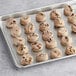 Preformed Otis Spunkmeyer Milk Chocolate Chunk cookies on a tray.