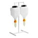 A white Asept 2-piece condiment dispenser set on a stand.