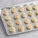 Preformed Otis Spunkmeyer sugar cookie dough on a baking sheet.