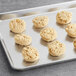 A tray of Otis Spunkmeyer preformed white chocolate macadamia nut cookies.