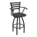A black Holland Bar Stool Jackie Ladderback swivel restaurant bar stool with a brown vinyl seat.