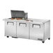 A True 3 door stainless steel commercial sandwich prep table with food on it.