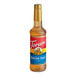 A Torani Winter Spice flavoring syrup bottle with a red label.