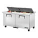 A True refrigerated sandwich prep table with food trays on a counter.