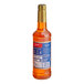 A close up of a Torani Sweet Heat flavoring syrup bottle with a blue label.