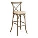 A Lancaster Table & Seating Vineyard Series Whiskey Brown outdoor bar stool with a tan cushion.