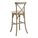 A Lancaster Table & Seating outdoor bar stool with a tan cushion.