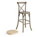 A Lancaster Table & Seating outdoor cross back bar stool with a Chardonnay tan cushion.