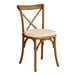 A Lancaster Table & Seating Vineyard Series Barrel Brown Outdoor Cross Back Chair with a Chardonnay Tan Linen Cushion.