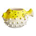 An Acopa yellow and white ceramic pufferfish mug.