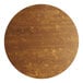 A Lancaster Table & Seating Vineyard Series round wood table with a brown finish.