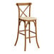 A Lancaster Table & Seating outdoor bar stool with a tan cushion on the seat.