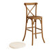 A Lancaster Table & Seating outdoor bar stool with a cross back and a white cushion.