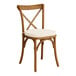 A Lancaster Table & Seating outdoor wooden chair with a white cushion.