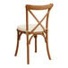 A Lancaster Table & Seating outdoor cross back chair with a white cushion.