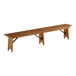 A long wooden bench with metal brackets on each end sitting on a wooden table.