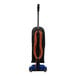 A black and orange Powr-Flite bagged upright vacuum cleaner with a cord and handle.