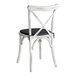 A white Lancaster Table & Seating outdoor cross back chair with a black cushion.