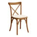 A Lancaster Table & Seating Vineyard Series wooden outdoor chair with a white cushion.