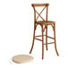 A Lancaster Table & Seating outdoor cross back bar stool with a Chardonnay tan cushion.