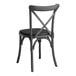 A Lancaster Table & Seating black metal outdoor chair with a black cushion.