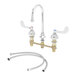 A chrome T&S deck-mount faucet with swivel gooseneck spout and wrist handles.