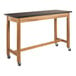 A National Public Seating wood science lab table with black chem-res top and wheels.