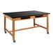 A black rectangular National Public Seating science lab table with casters.