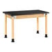 A black rectangular table with wooden legs.