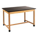 A black National Public Seating science lab table with wooden legs and a wood top.
