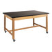 A black National Public Seating wood science lab table with casters.