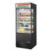 A True refrigerated air curtain merchandiser with glass sides and a variety of food and drinks on display.