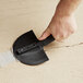 A person using a Midwest Rake flexible radius trowel to remove a crack in cement.