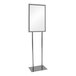 A white rectangular sign on a metal stand with a grey rectangular base.