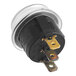A round black Lavex rocker switch with gold metal parts.