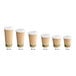 A row of brown Kraft paper coffee cups with white PLA lids.